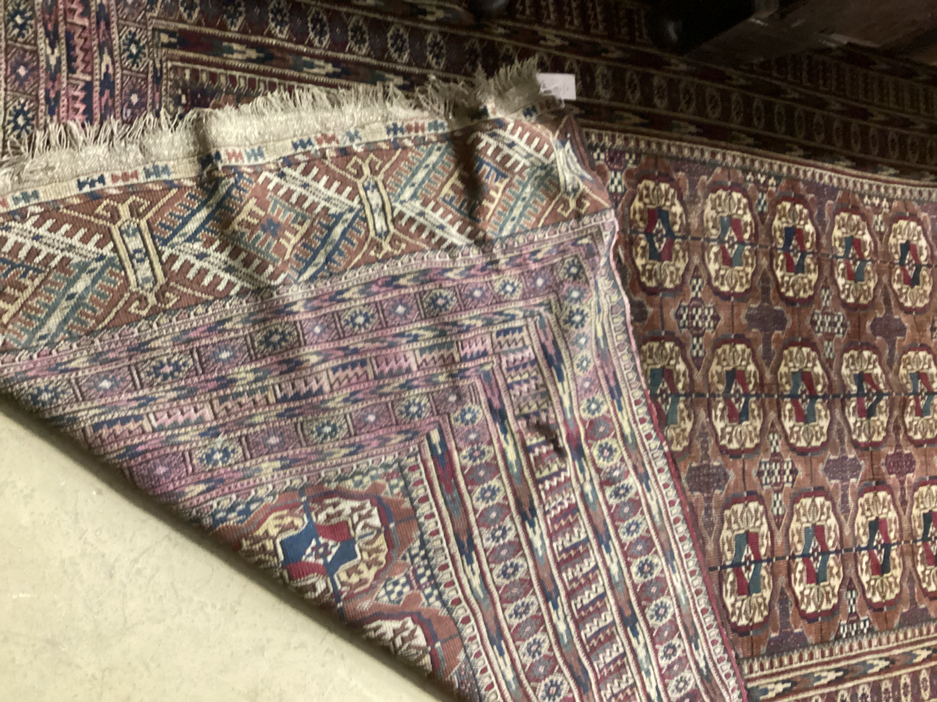 A Bokhara burgundy ground rug, 260 x 160cm